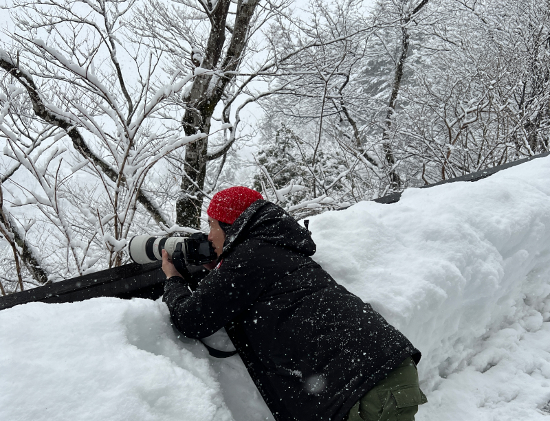 Yuto in the snow taking a photo